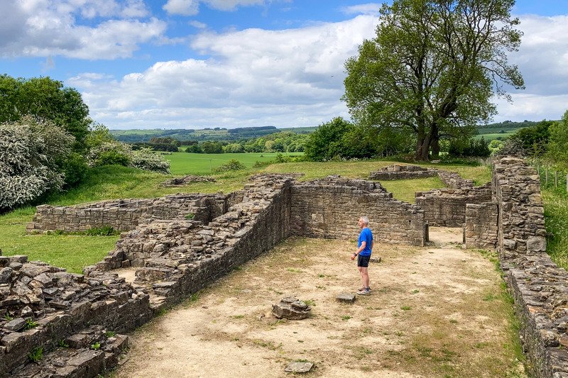 Man in running gear exploring ruins