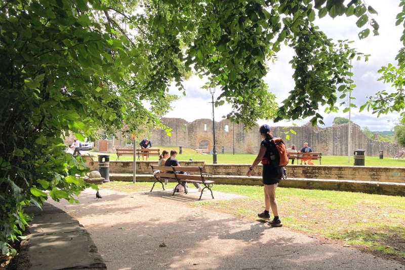 Hiker passing the castle green at Barnard Castle