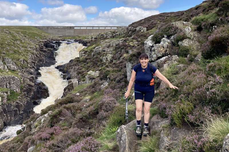 hiker by a waterfall